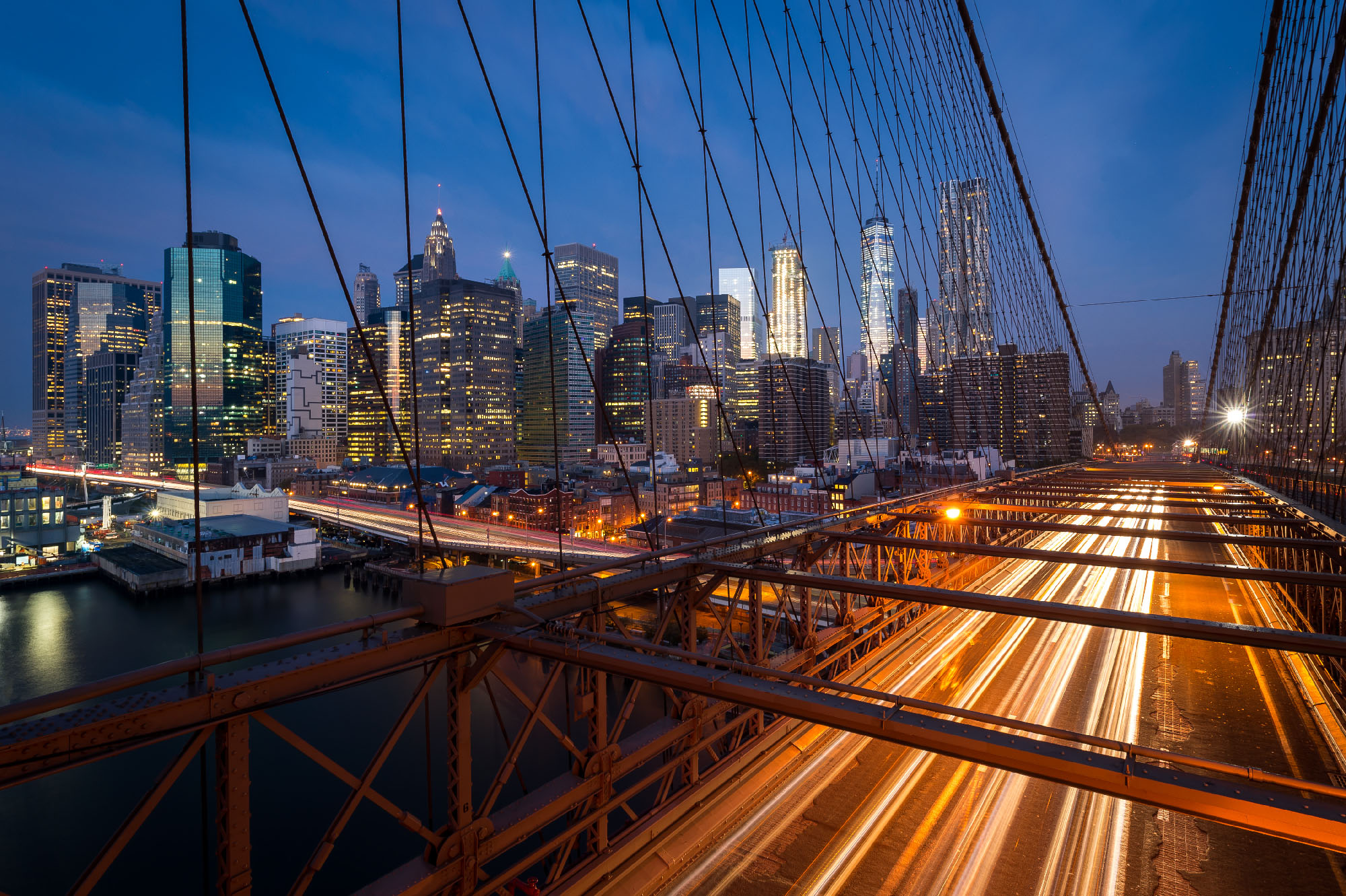 Traffic on the Brooklyn bridge with Lower Manhattan city skyline in the background